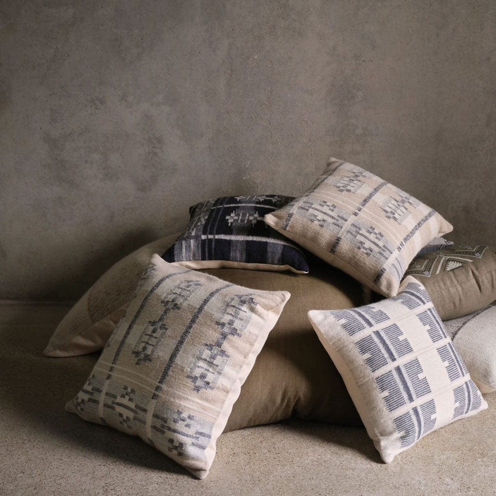 Pile of navy and ecru pillows, stone-blue