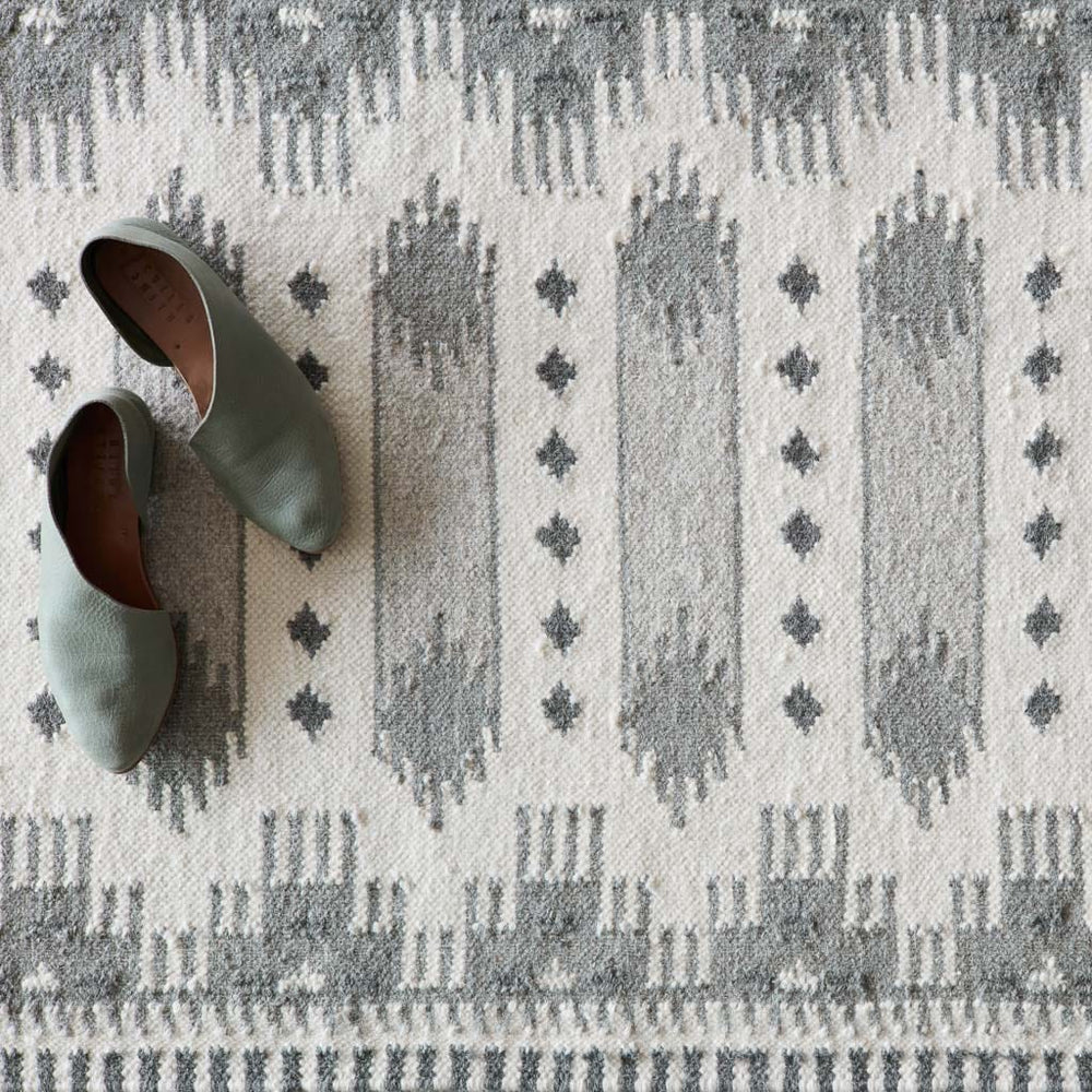Detailing of Grey Kilim Rug with Green Shoes