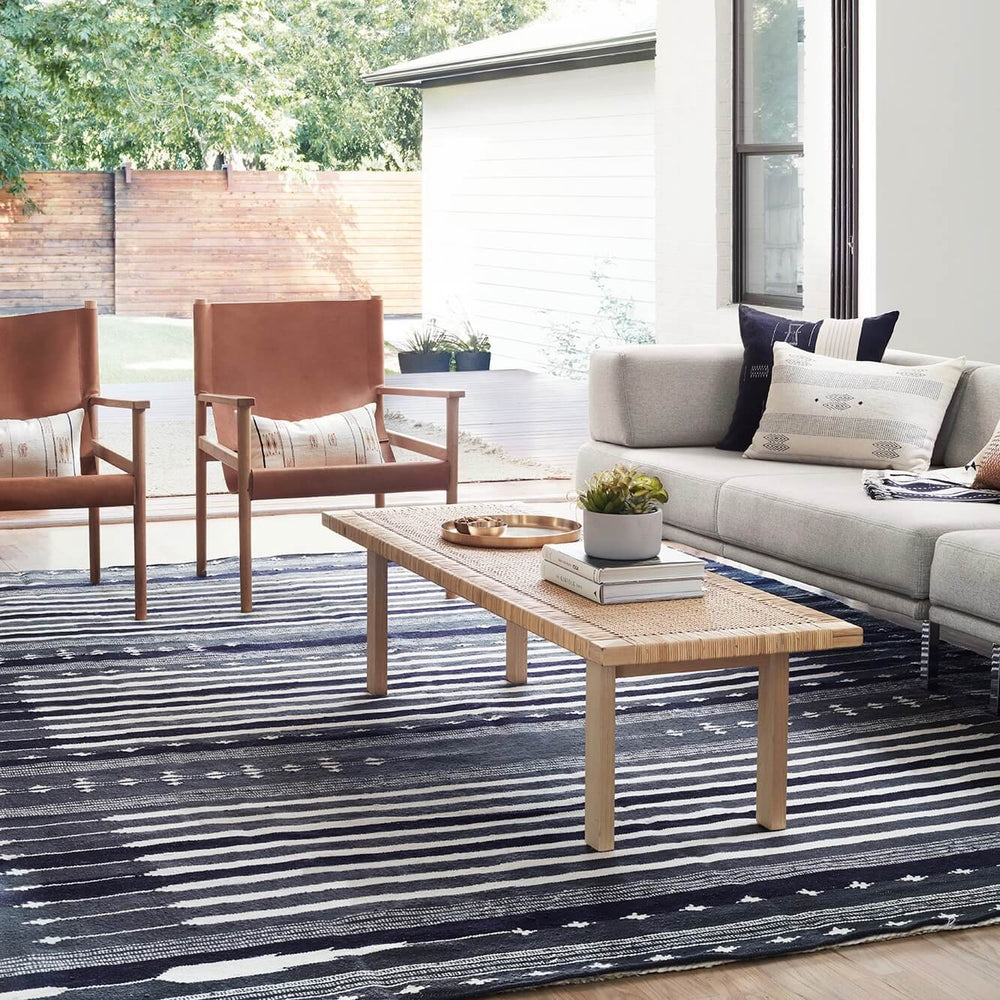 Navy Area Rug in Modern Living Room with Safari Chairs