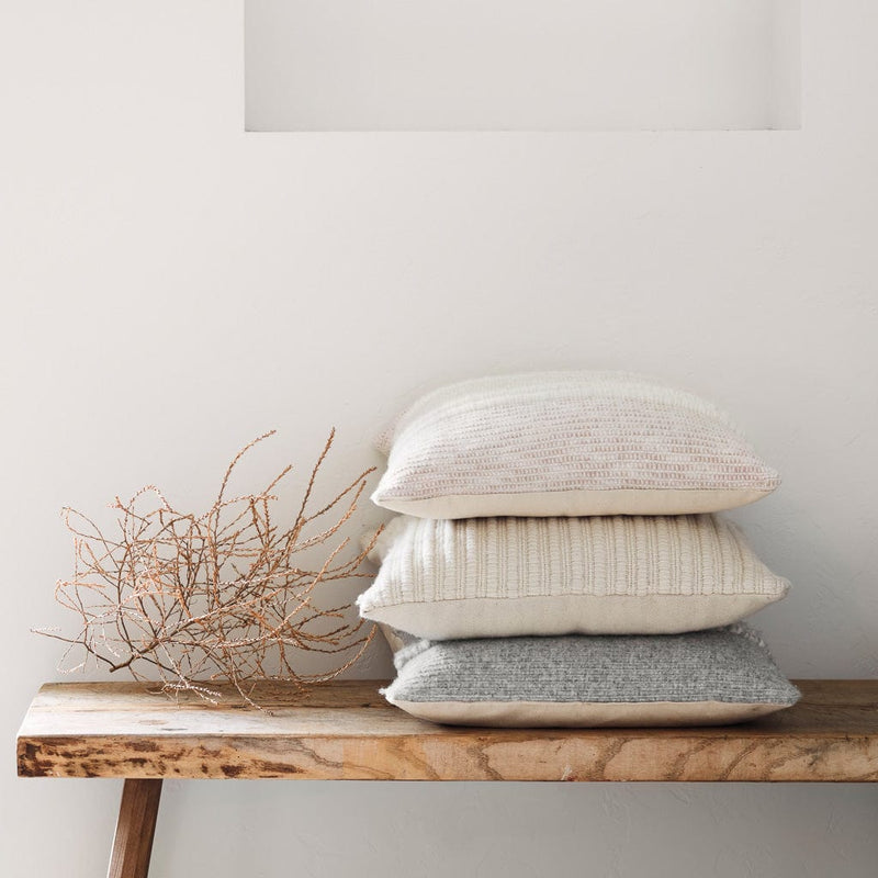 Stack of Neutral Alpaca and Wool Pillows on Bench, grey