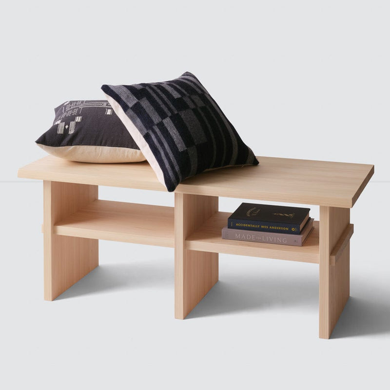 Hinoki wood bench with throw pillows and books, natural