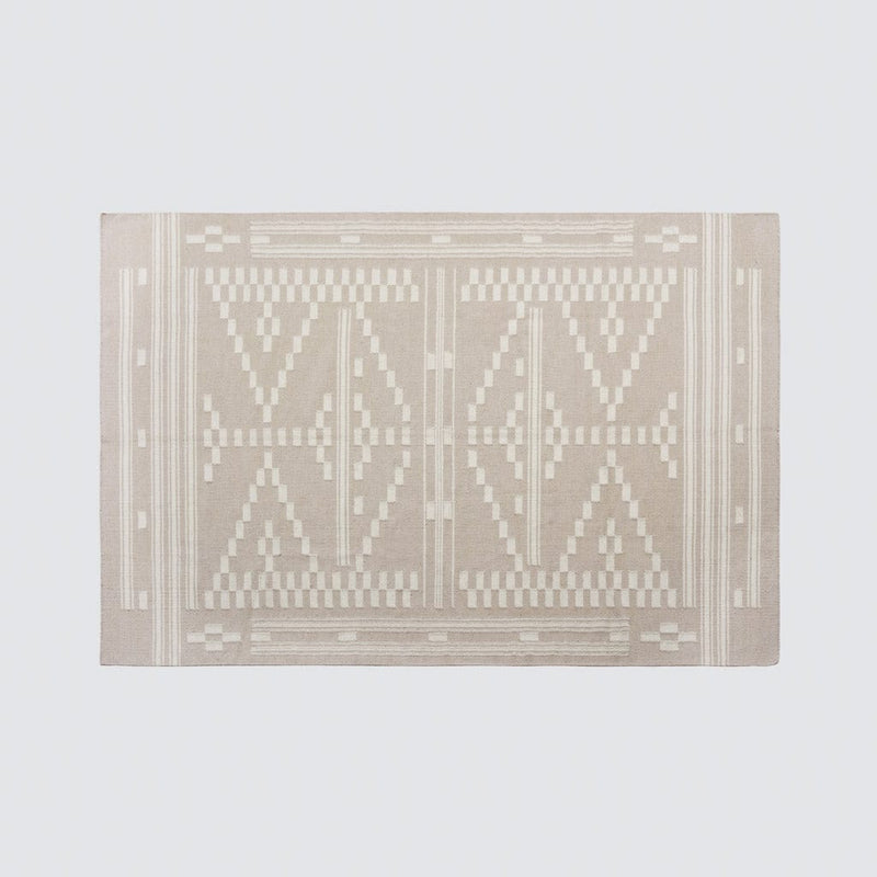 Overhead of patterned woven rug, flax