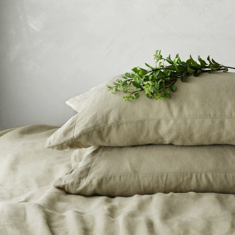 Stack of two sage green pillows, sage