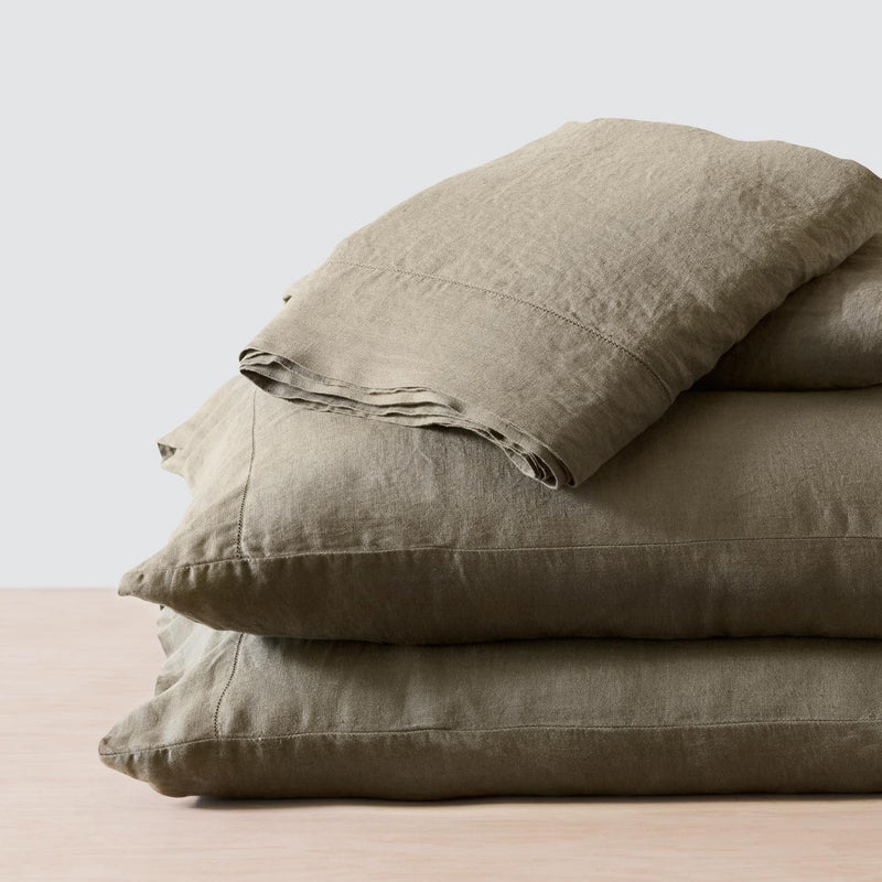 Folded Stack of Olive Linen Sheets and Pillowcases, olive