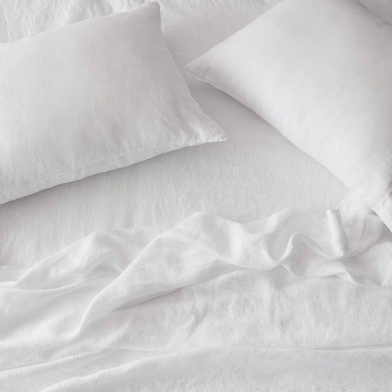 overhead of white linen bedding, white