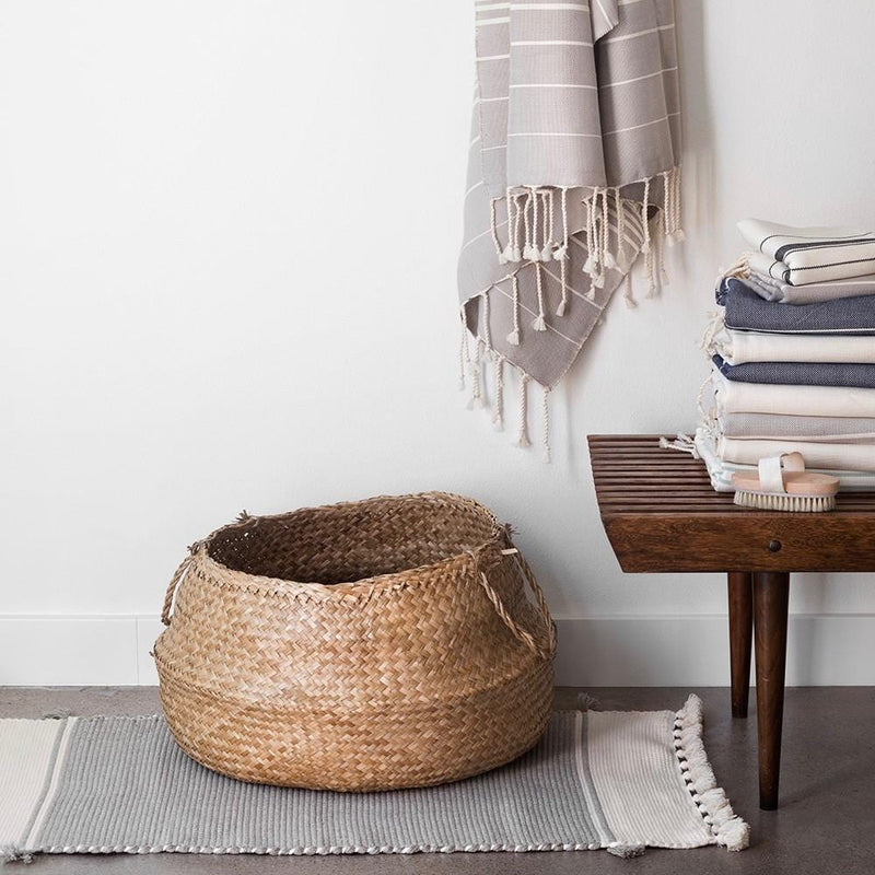 Woven bath mat under woven basket, stone-grey