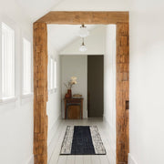 Jute runner in hallway with beams, black