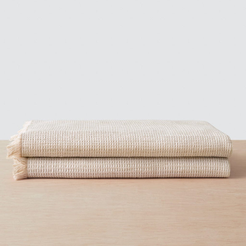 Stack of two waffle weave bath towels, tan
