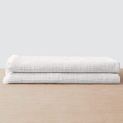 Stack of two waffle weave bath towels, white