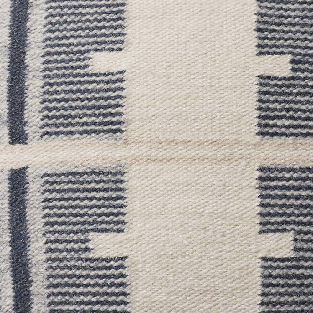 Detail of navy and ecru stitching, stone-blue