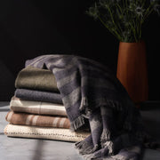 Folded stack of alpaca throws, tan