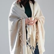 Model holding mug with Striped alpaca throw with Fringe, sand