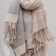 model holding Striped alpaca throw with Fringe, sand