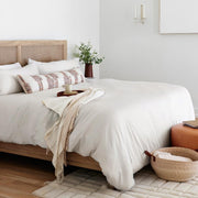 Striped alpaca throw with Fringe styled on bed, sand