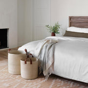 Striped alpaca throw with Fringe styled on bed, sand