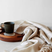 Striped alpaca throw with Fringe styled on tray, sand