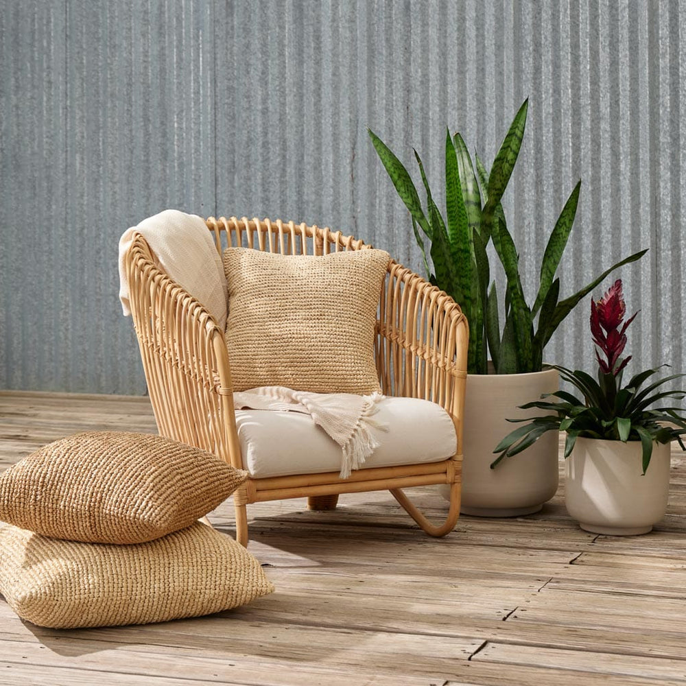 Ceramic planters next to rattan lounge chair