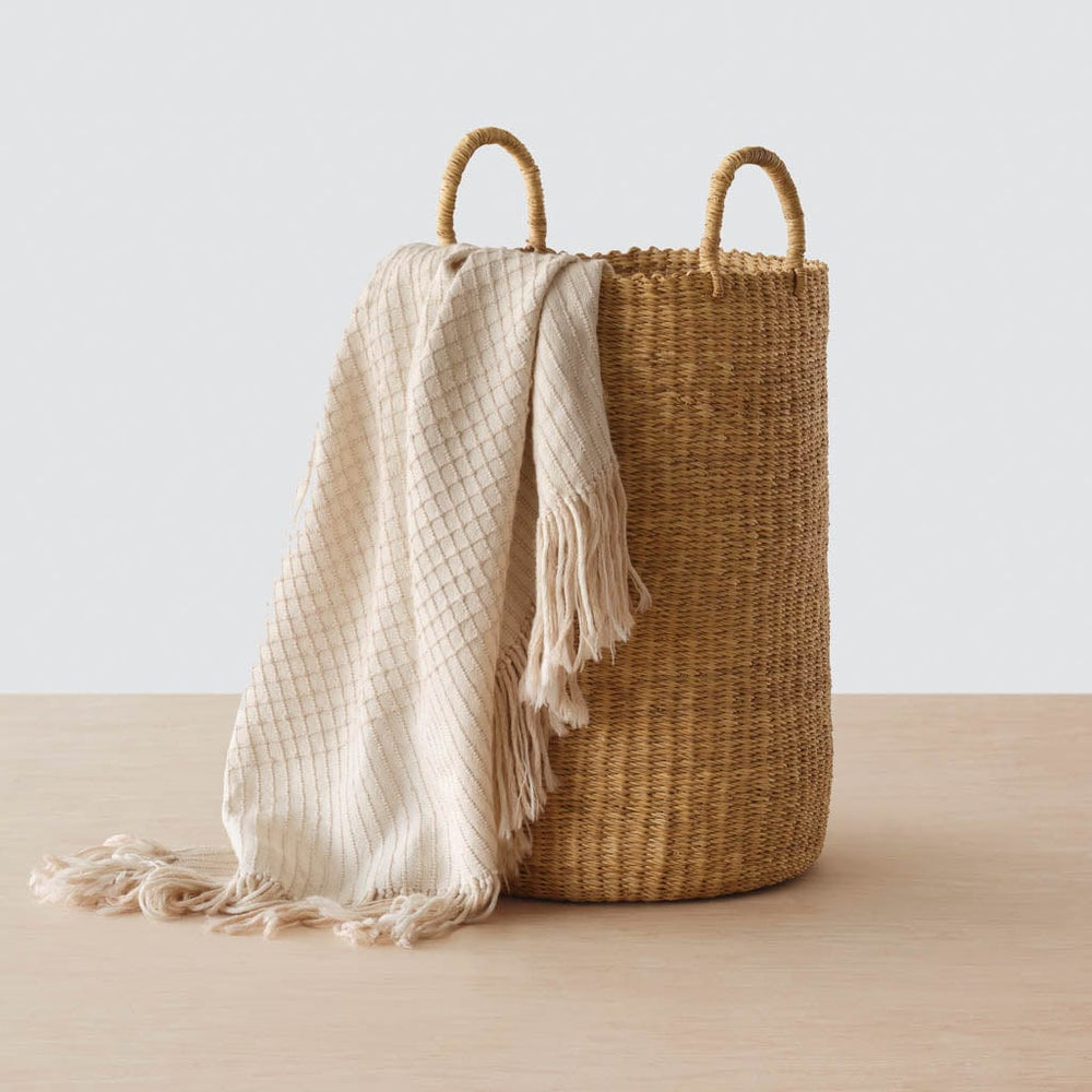 Pair of Handwoven Baskets in Natural Materials styled with blanket