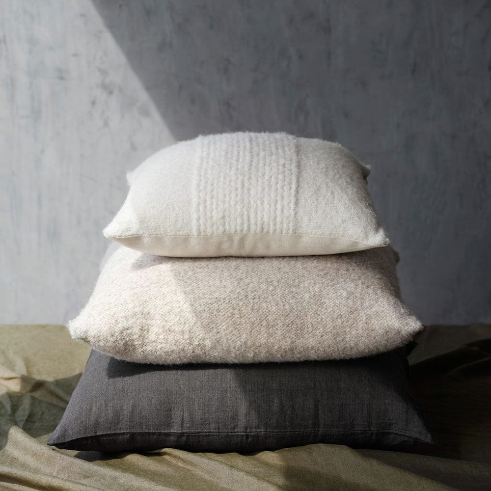catalina boucle pillow piled on throw pillows, tan