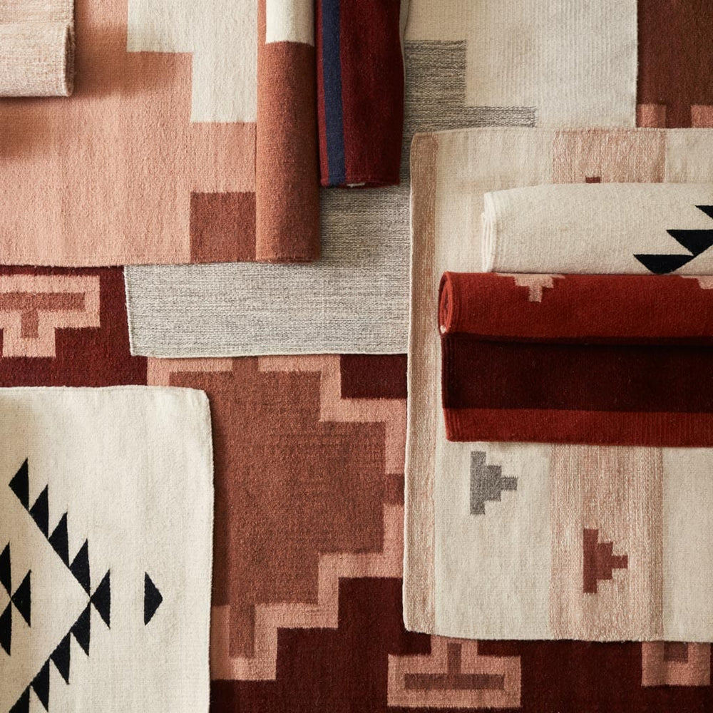 Handwoven Wool Accent Rugs in Rust and Neutral Tones Layered Overhead
