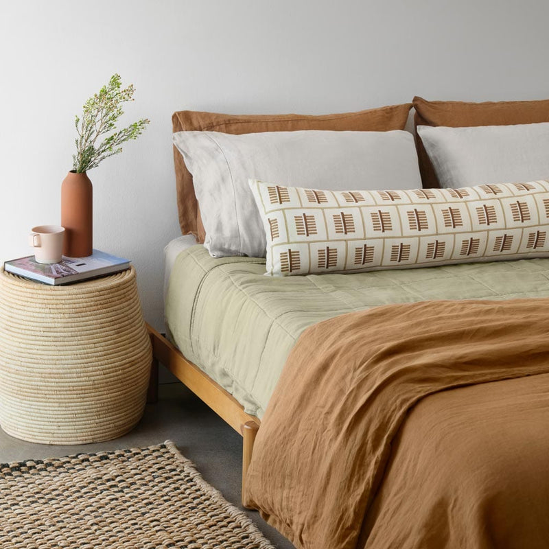 Styled bedroom with block printed lumbar and sage green linen quilt, sage