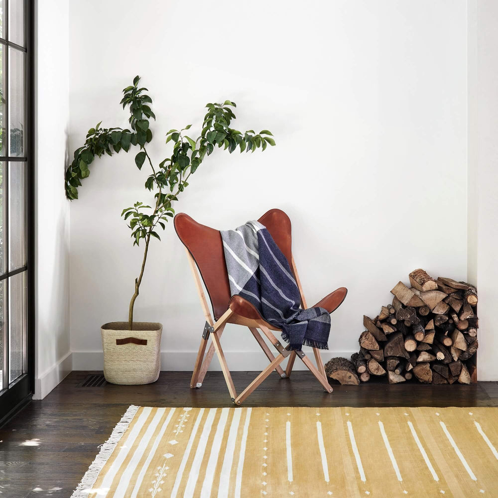 Striped Yellow Dhurrie Rug with Leather Chair