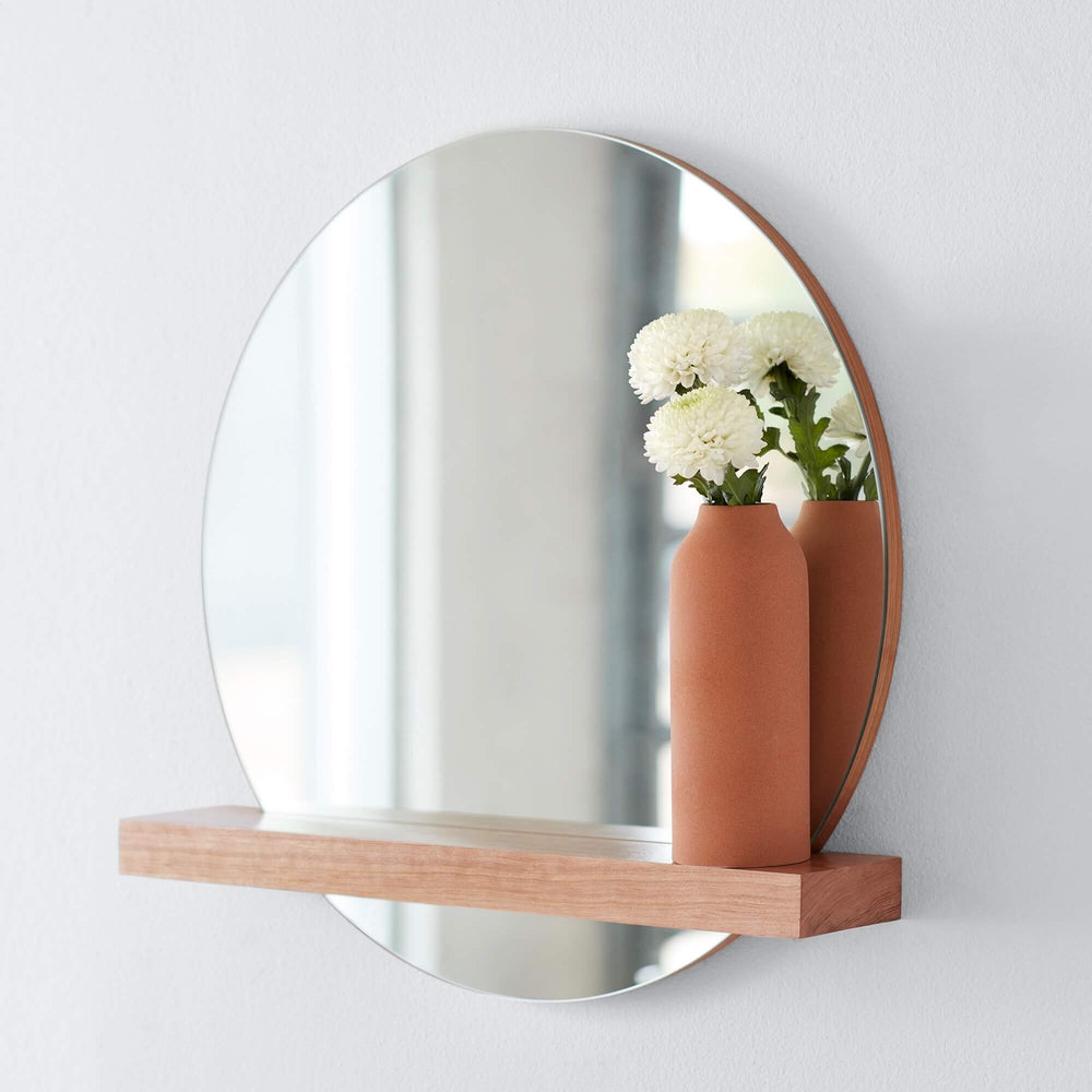 Circular Wall Mirror with Wood Shelf and Clay Vase 