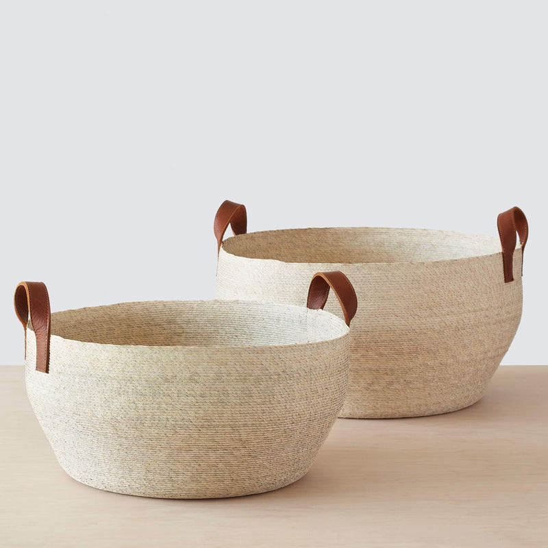 Set of two handwoven palm baskets with leather handles, natural