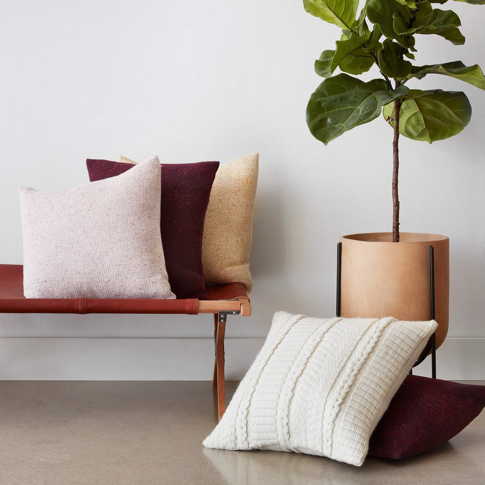 Pillows Styled on Bench Next to Potted Plant