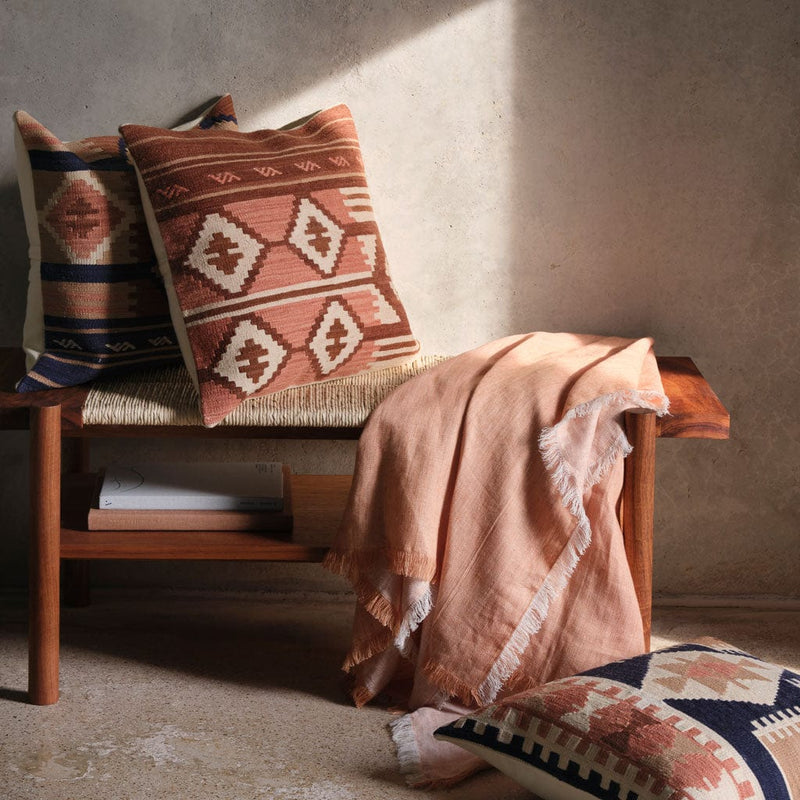 Wooden bench with Kilim pillows and soft pink linen throw,sienna