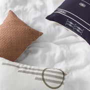 Overhead View of Leather and Embroidered Pillows on Bed, natural