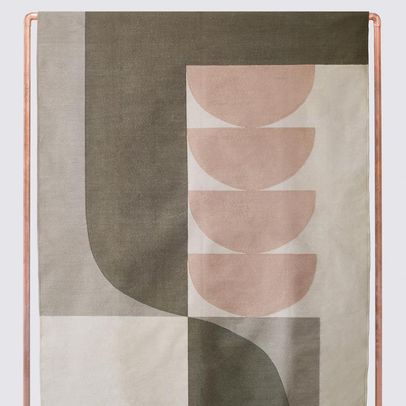 Abstract woven area rug in olive and blush and tan hues, olive
