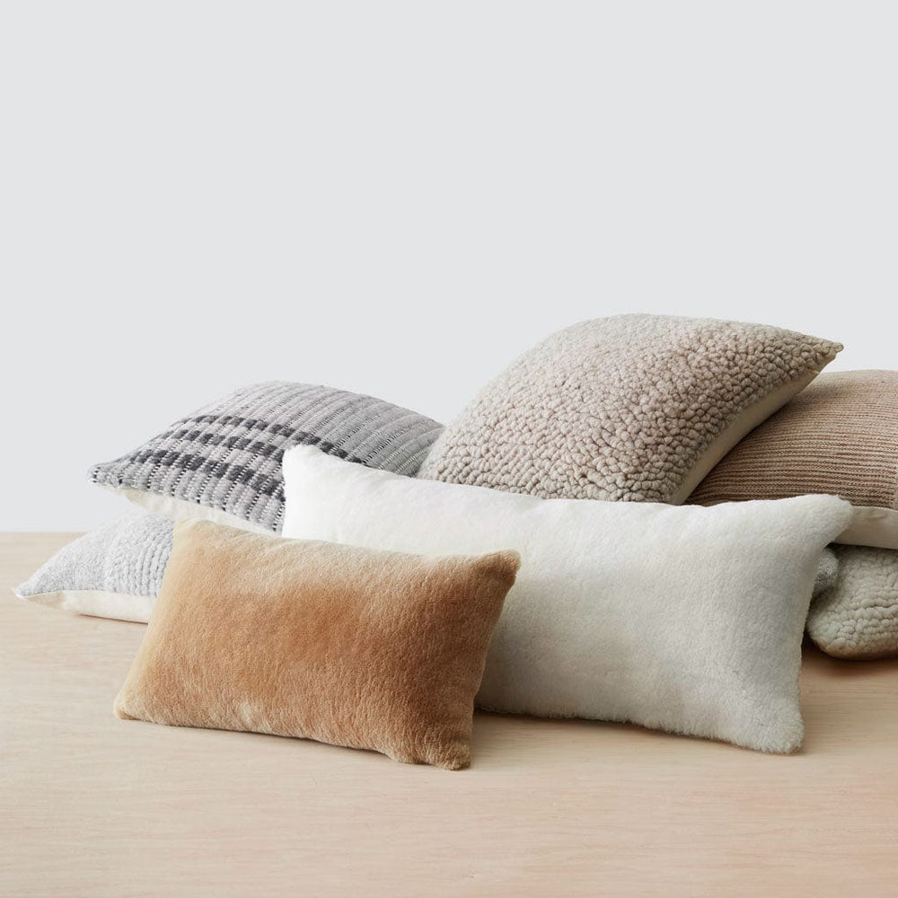 Pile of woven and shearling pillows