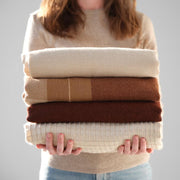 Alpaca throw with other throws tan and rust, rust