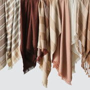 Cream tan rust and rose alpaca throws hanging, rust