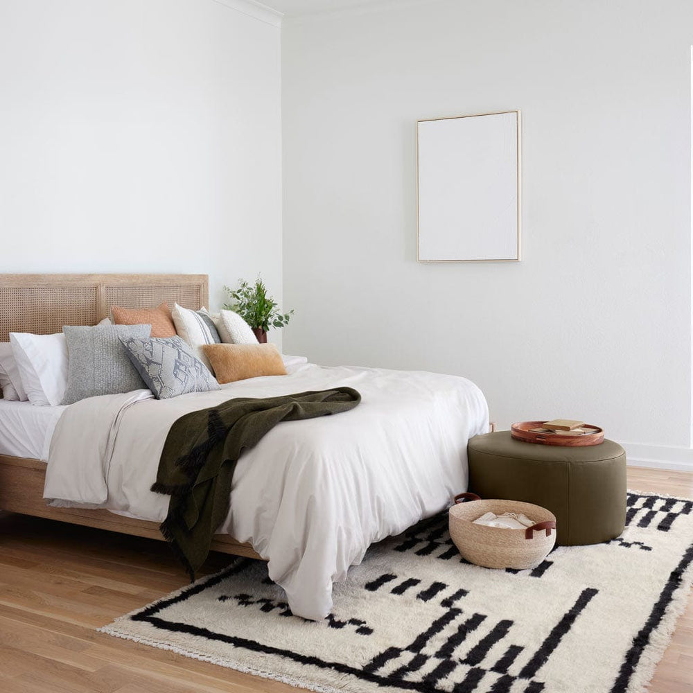 Modern Bedroom  with Black and White Turkish Rugs and Olive Ottoman
