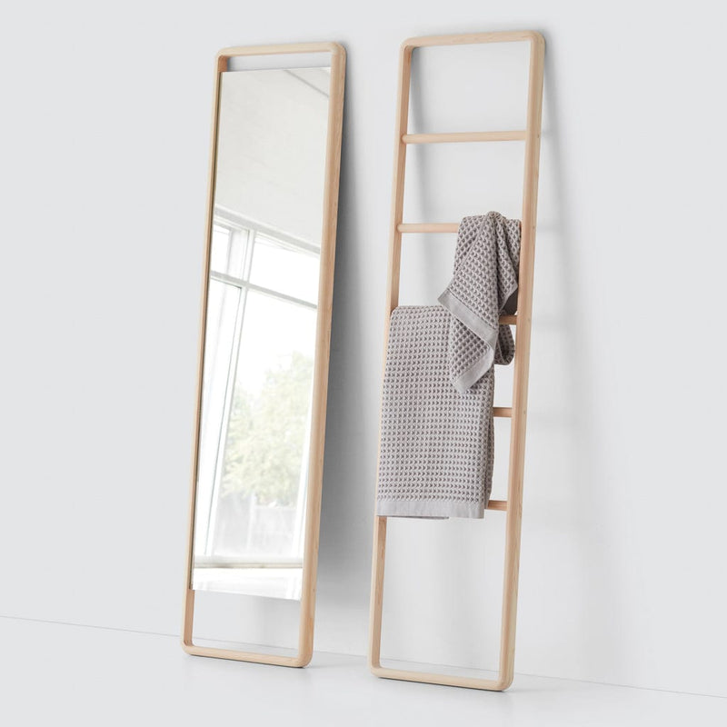 Waffle towels hanging on wooden ladder next to mirror, natural