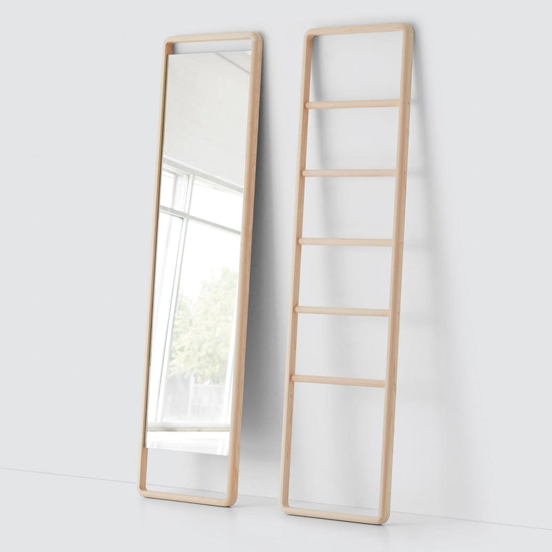 Light wooden ladder next to wooden mirror, natural