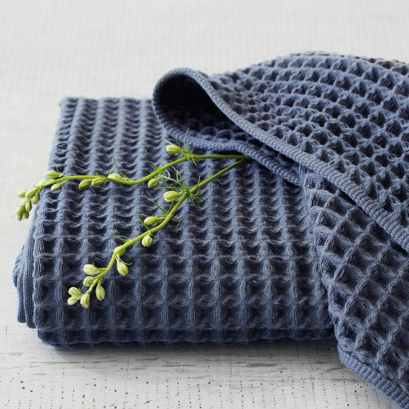 Folded navy waffle towels with greenery,indigo