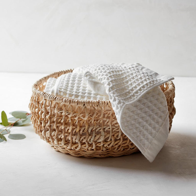 Small waffle towels in woven basket, white