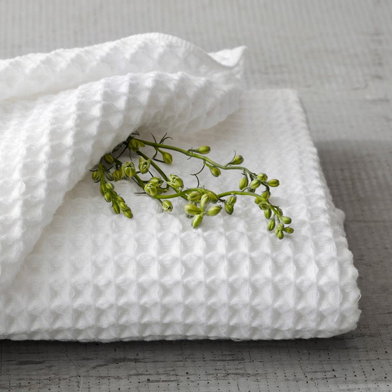 Folded waffle towels with greenery, white