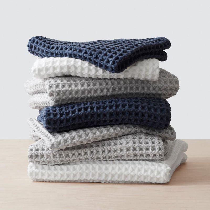 Stack of waffle multi-colored waffle weave towels, white