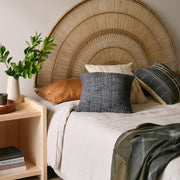 Wool textured pillow styled on bed, navy