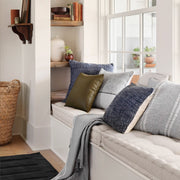 Wool textured pillow styled on bench by windows, navy