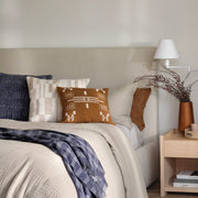 Wool textured pillow styled in bedroom, navy