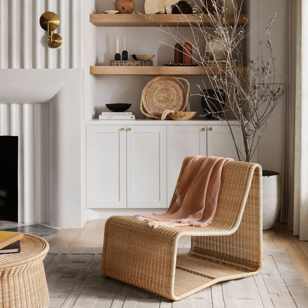 Modern wicker chair with lightweight linen blanket