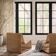 Liang wicker chairs in front of window