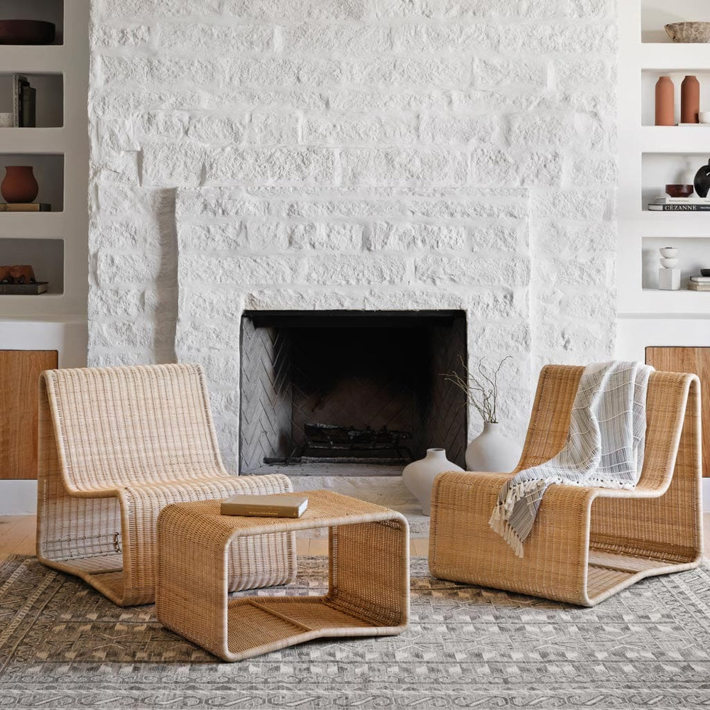 Woven wicker ottoman with wicker chair in living room