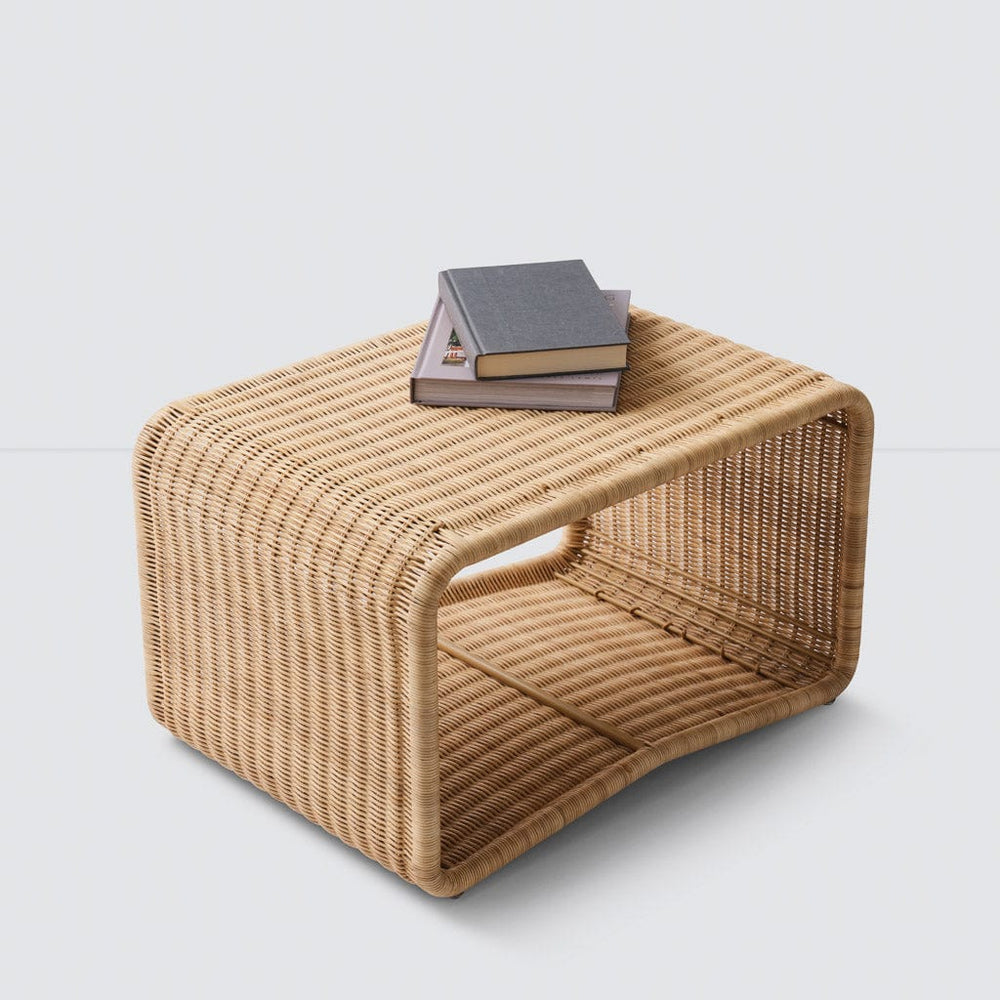 Liang sculptural wicker ottoman with books