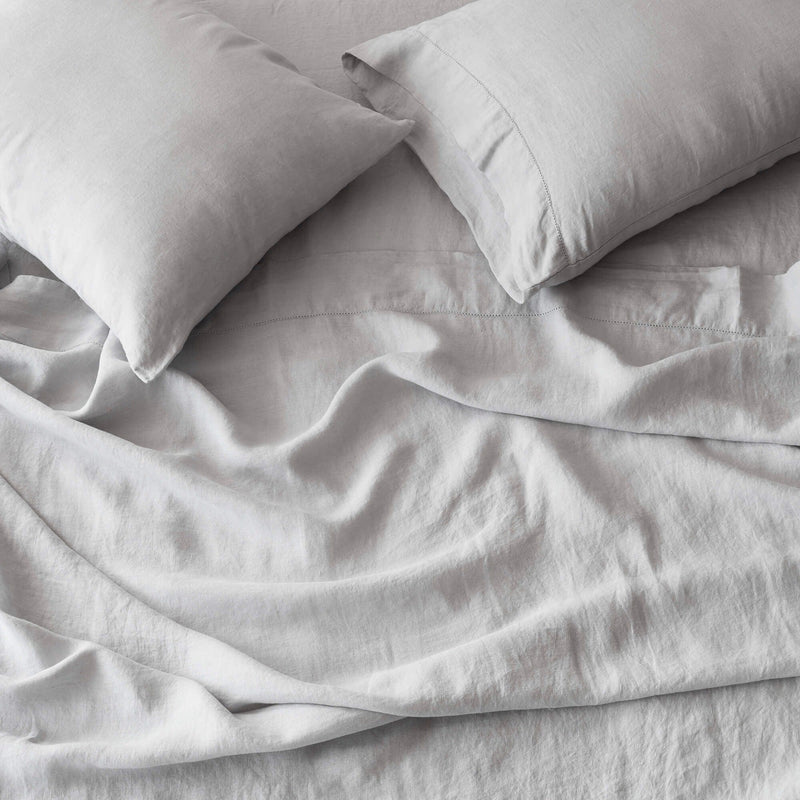 overhead of soft grey linen bedding, light-grey